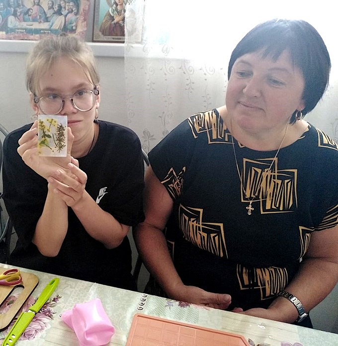 Девочка держит в руке кусок изготовленного мыла
