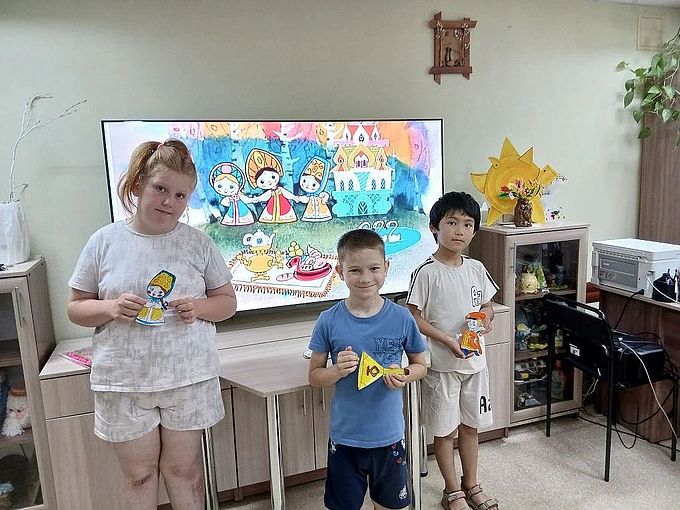 Дети показывают раскрашенные бумажные фигурки